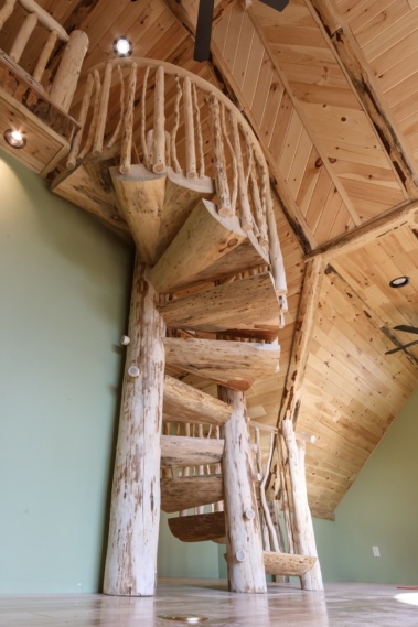 Custom rustic log split spiral stairs, log split spiral staircase with custom rustic log twig railings by Adirondack LogWorks